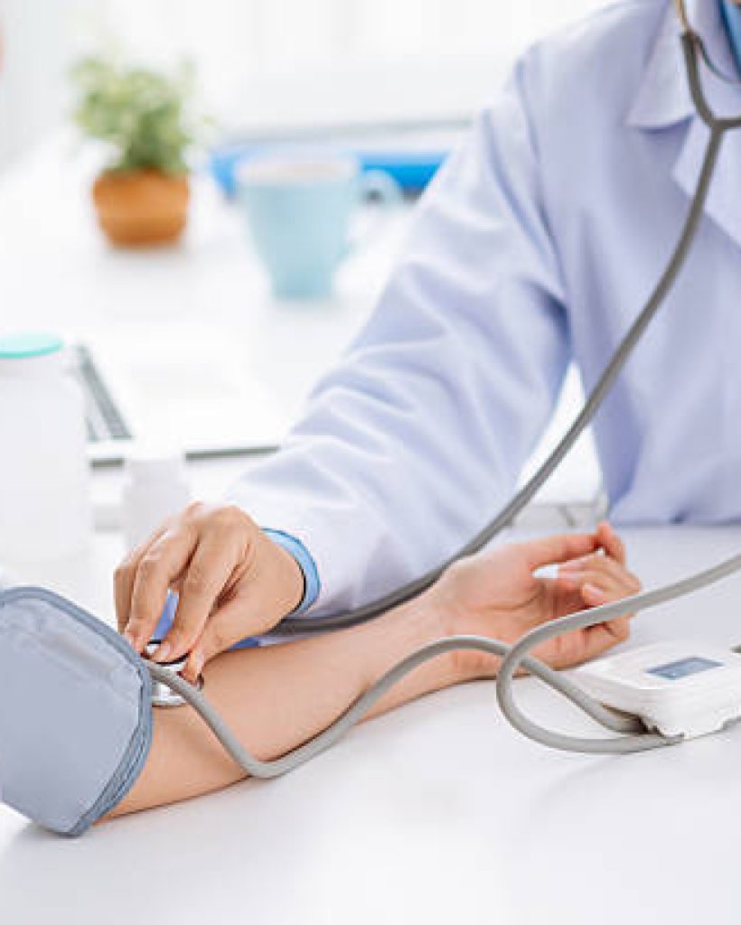 Doctor checking blood pressure of the patient, selective focus