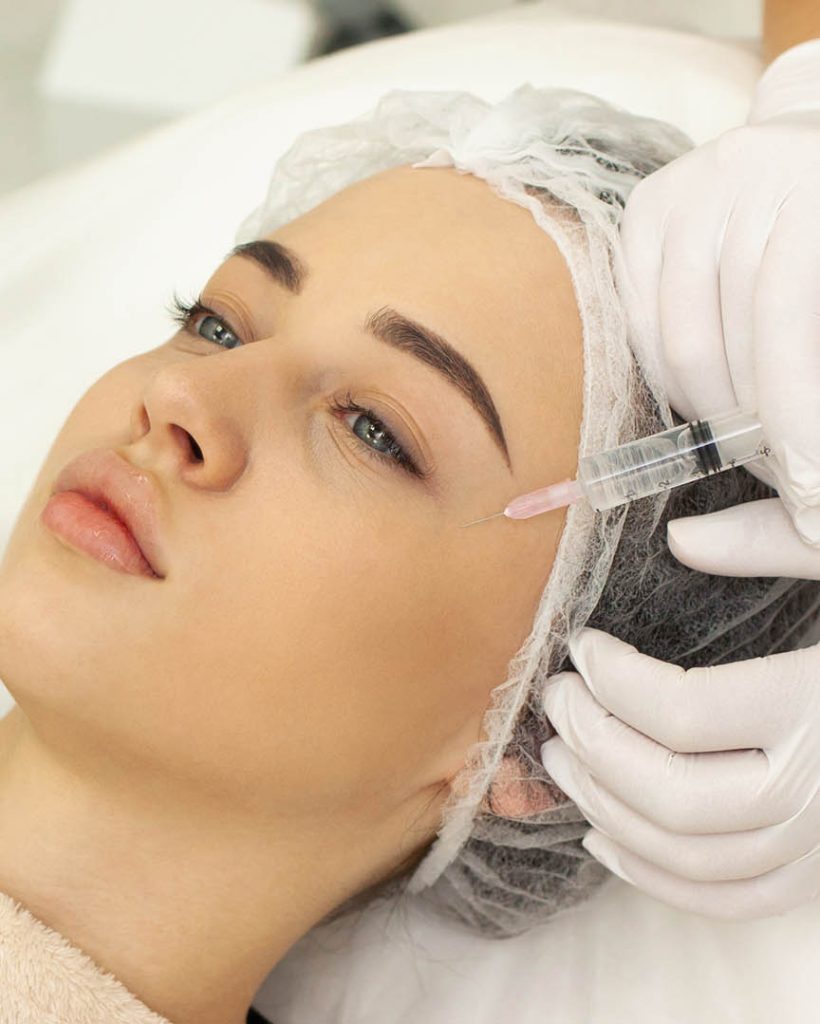 Woman at the beautician. The concept of injection cosmetology, anti-aging procedures.